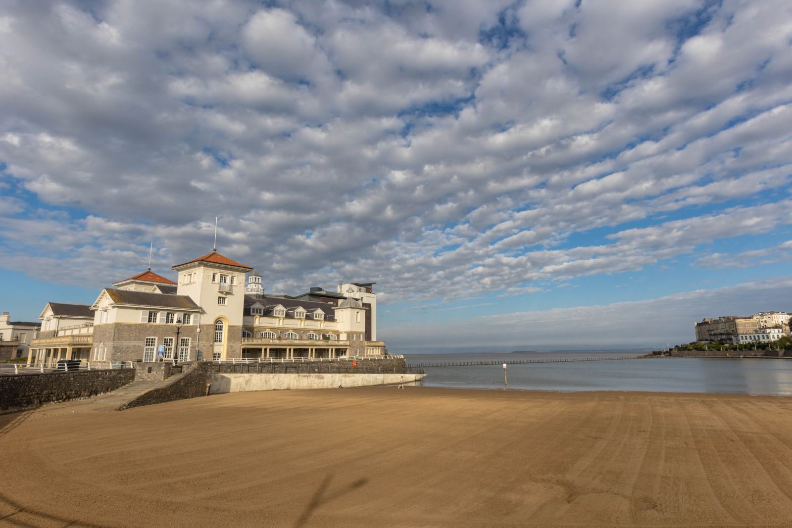 View of an empty Marine Parade beach with the buiiiildings of knknknknknightsone Islands, Weston-super-Mare to view on the left